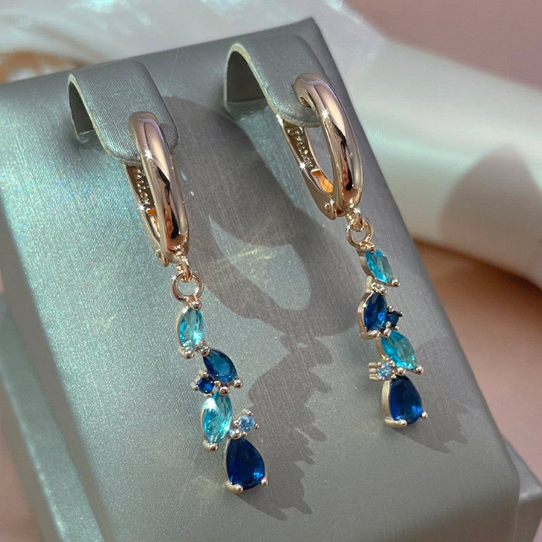 Fascinantes brincos em azul brilhante e cristal dourado cintilante